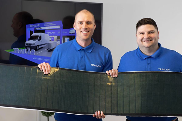 TRAILAR co-founders holding one of the company's solar mats