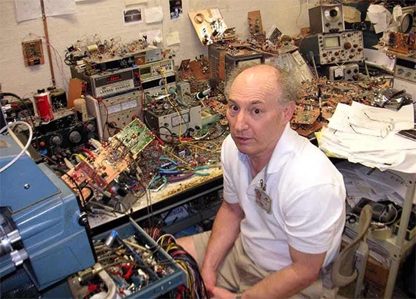 The legendary analog circuit design genius Jim Williams looking up from his famous, hyper-cluttered workbench at Linear Technology Corp.