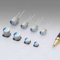 A variety of polymer capacitors with a pen for scale Polymer Capacitors