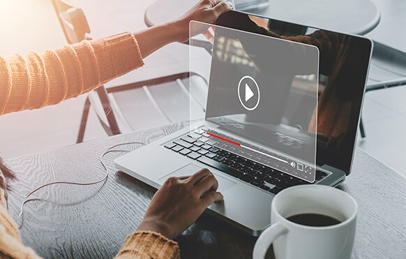 Person viewing a video player on a laptop