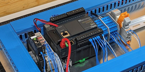 PLC trainer on the author's workbench featuring a Schneider PLC.