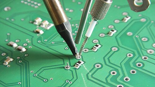 Image of robotic arms performing selective soldering in pc board production