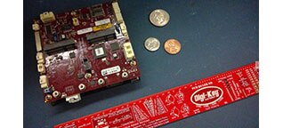 Image of VersaLogic’s Raven EPU Next to a Ruler and U.S. Coins for Size Comparison