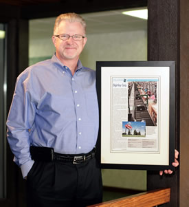 Paul Dosser proudly displays Digi-Key Electronics' 2014 Progress Minnesota Award