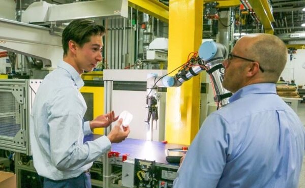 Image of In-Position Technologies' An Engineer Assists a Customer with a Robot